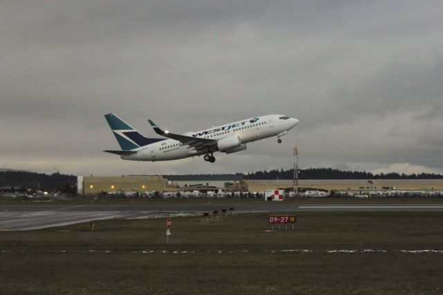 Boeing 737-700 (C-FWSV) - Standing At Viewing Area At End Of 27. Photo Taken With Canon EOS Rebel T5 With 18-55mm lens