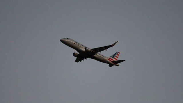 Embraer 170/175 (N231AN) - An evening departure from DFW as seen from Founder's Plaza. Not a lot of light to work with!