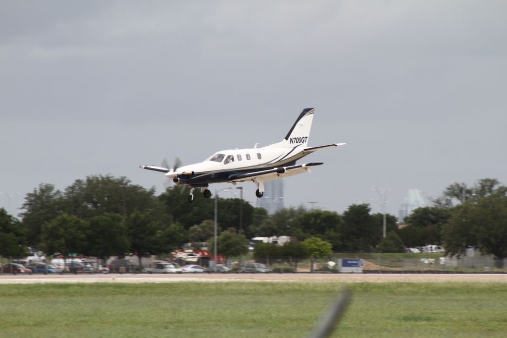 Socata TBM-700 (N700GT) - N700GT comes screaming in at a high airspeed, and after floating in ground effect down the runway, lands on the nose gear. The TBM-700 has a strong nose gear!