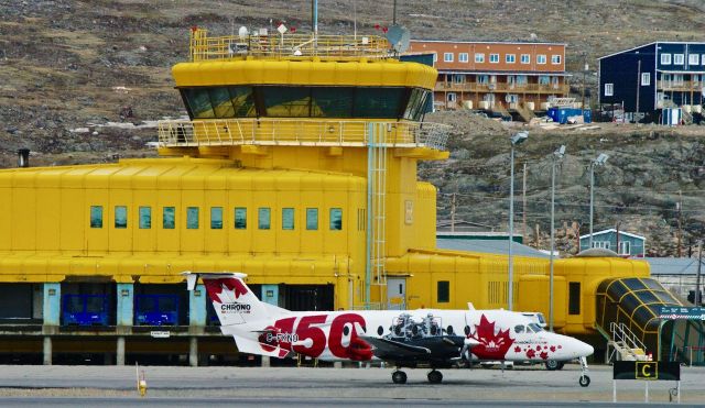 Beechcraft 1900 (C-FKNO) - Special Canada 150th Livery by Chrono Aviation with Iqaluit, Nunavut in the Background #CFKNO Taken my me and part of the #YFBSpotters Group. Beautiful Spring Day here at +8