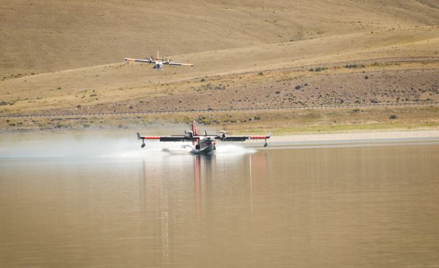 — — - A pair of CL-215-6B11 (CL-415) operating from Clark Canyon Reservoir near Dillon Montana on the Bear Creek Fire