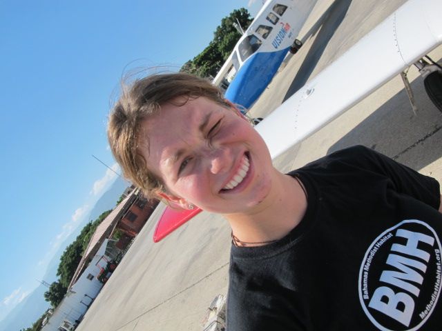 Beechcraft 55 Baron (N74EM) - The lovely Ms Cameron King on the ramp at Port au Prince airport after replacing the starter on a Baron and a vacuum pump on a Piper Arrow.  See the grease on her face?  Shes a mechanic and a fine pilot.