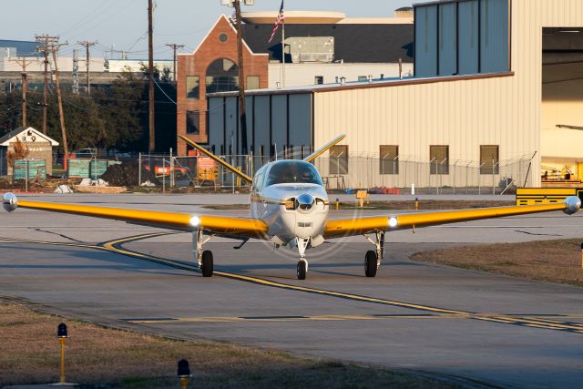 Beechcraft 35 Bonanza (N8983A) - A beautiful V-tail Bonanza taxiing in at Addison after a late evening flight.