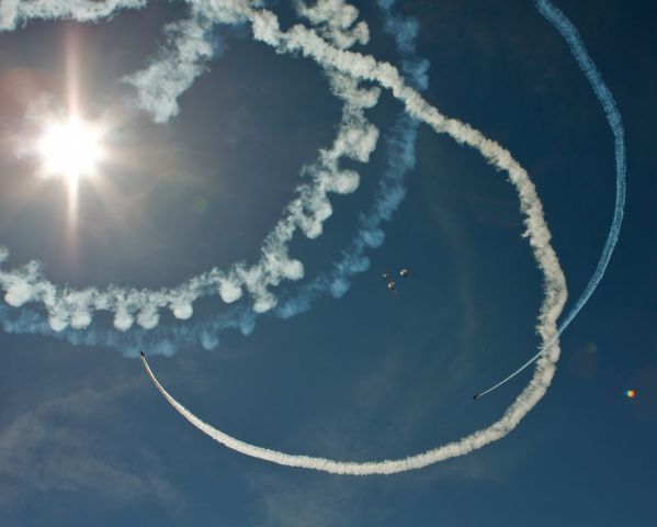 — — - A couple of aircraft circle the Red Bull sky diving team as they descend into the Joint Base Andrews Air Show.  May 18, 2012.