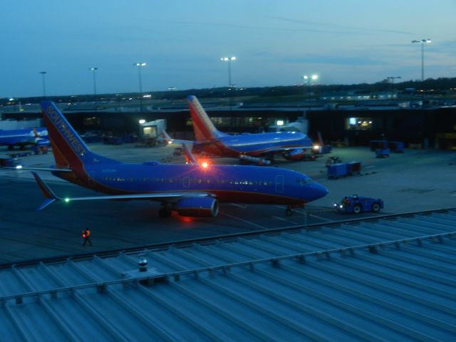 Boeing 737-700 (N256WN) - N256WN, A Boeing B737-7H4 Of Southwest Airlines, Is Pushed Back From The Gate On A Late Spring Evening, N256WN Was Built In 2006