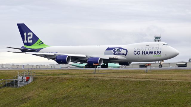 BOEING 747-8 (N770BA) - Painted to honor the Seattle Seahawks football team and their fans, BOE573 taxis to Rwy 34L for a flight test on 1/31/14.(LN:1437 cn 37564).