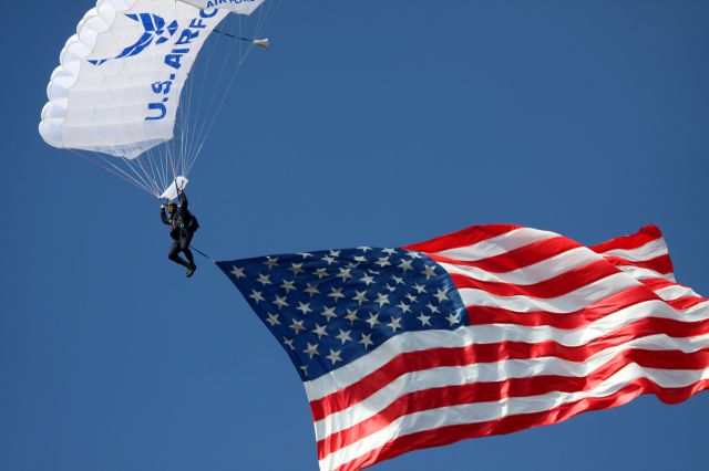 — — - At "Wings OVer Wine Country" the United States Air Force Academy Jump Team, "Wings Of Blue" brought in the American Flag, during the Star Spangled Banner