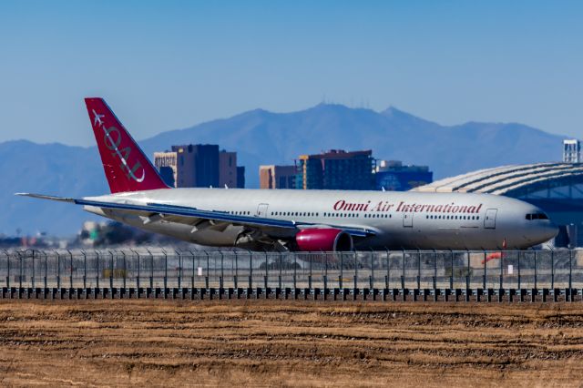 Boeing 777-200 (N828AX) - An Omni Air International 777-200 landing at PHX on 2/10/23 during the Super Bowl rush. Taken with a Canon R7 and Canon EF 100-400 II L lens.