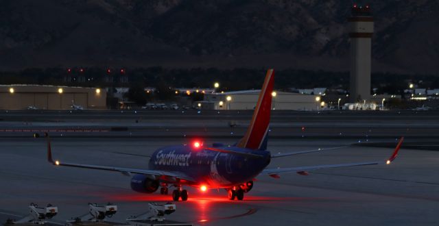 Boeing 737-700 (N954WN) - Southwest's "Disney World 50 Years" special livery taxiing away from the Southwest apron in the final few moments of dusk light before full nighttime darkness encompasses the airport grounds.