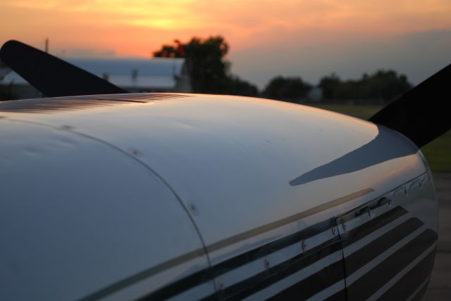 Cessna Chancellor (N8195Q) - A reflective view of sunset off the left engine nacelle.