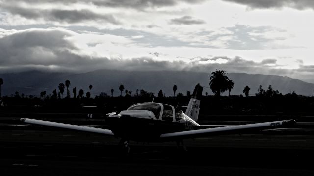 Socata TB-20 Trinidad (N20GU) - Transient Socata Trinidad sitting on the transient ramp with a storm approaching at Reid Hillview Airport.