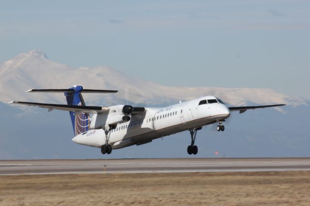 de Havilland Dash 8-400 (N332NG) - Taking off on runway 8 at DIA with Longs Peak in the background.