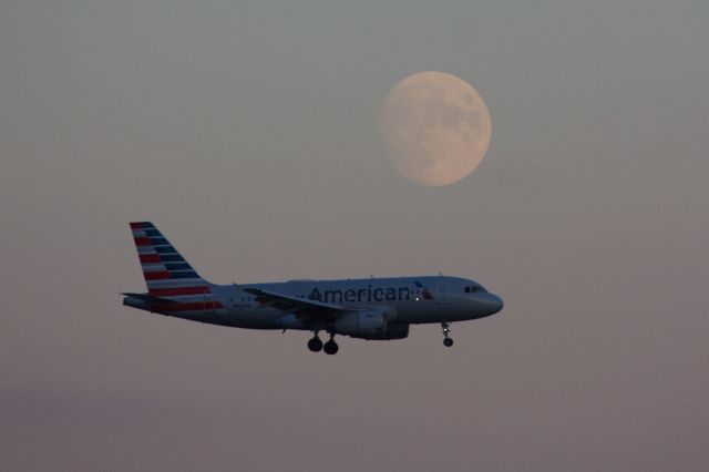 Airbus A319 (N803AW) - An American Airlines A319 landing at Boston Logan at dusk with the nighttime moon starting to make her appearance for the evening.   