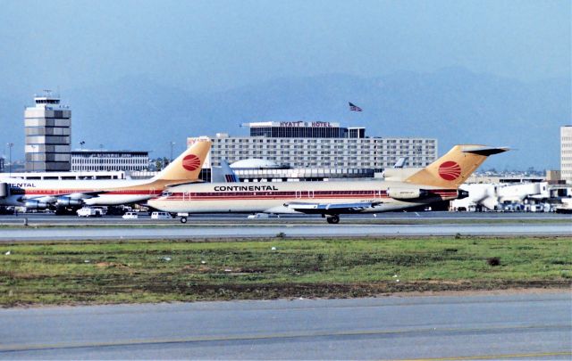 BOEING 727-200 (N574PE) - KLAX - from the Imperial Terminal parking lot circa Sept 1989 Continental 727 arriving 25L and rolling onto the exit chute to cross 25R when cleared. This is a lower angle sun shot late PM - one of the greater airliner photography spots back in the day - I was in LA for the Fall airline collectible show that year.