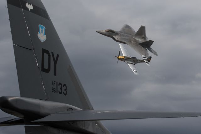 Lockheed F-22 Raptor (AALF09190) - F-22 and P-51 in formation flight over B-1 bomber tail at Arctic Thunder at Elmendorf AFB, Alaska. July 31, 2016