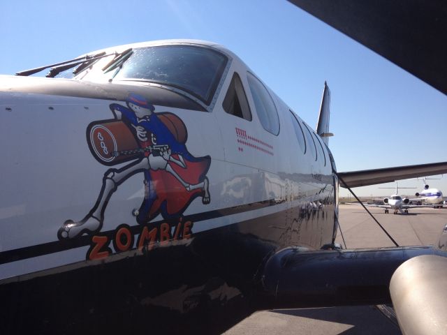 Beechcraft King Air 90 (C-FMFZ) - Nose art and mission count.