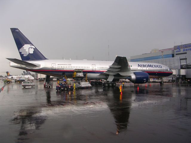 Boeing 777-200 (N745AM) - condition: wet runway