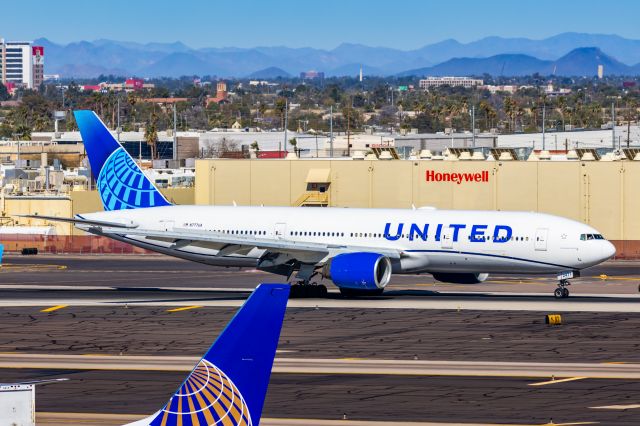 Boeing 777-200 (N777UA) - A United Airlines 777-200 landing at PHX on 2/10/23 during the Super Bowl rush. Taken with a Canon R7 and Canon EF 100-400 II L lens.