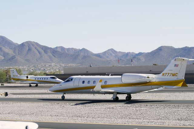 Learjet 60 (N777MC) - N777MC, and its twin N273MC departing Scottsdale Airport.