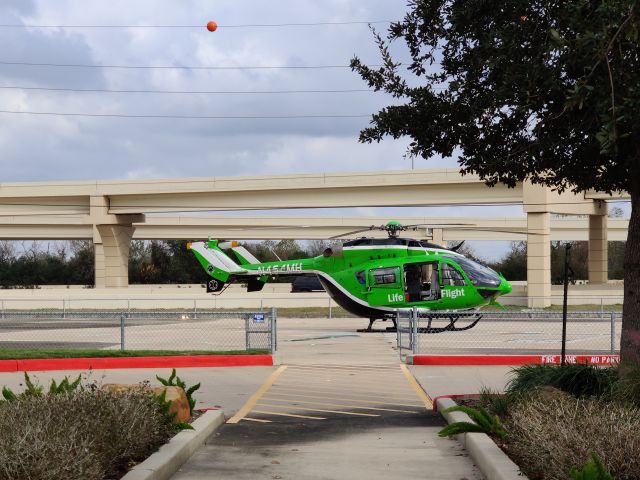 KAWASAKI EC-145 (N454MH) - West of the helipad, facing East, at the Northeast corner of Memorial Hermann Pearland Hospital.  Visible in the background is Texas SH-288 (South Fwy) and two elevated ramps connecting the frontage road and express toll lanes (Brazoria County Expressway).