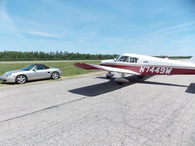 Piper Cherokee (N7449W) - outside of the hanger parked next to the little Porsche