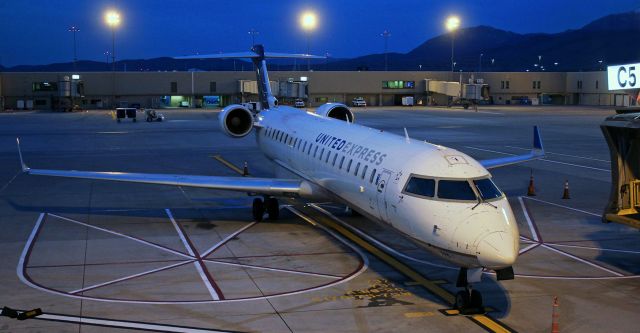 Canadair Regional Jet CRJ-700 (N795SK) - The early dawn light is beginning to brighten the sky over Slide Mountain in the distance while this CRJ-700 sits in the alley until later in the morning when it will depart to SFO.