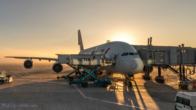 Airbus A380-800 — - Sunrise over Charles de Gaulle Airport and an Air France A380 getting ready to load up and go.