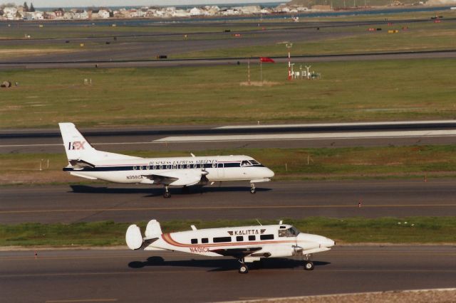 Beechcraft 18 (N401CK) - A couple of commuters taxi at Boston Logan on April 22, 1998.