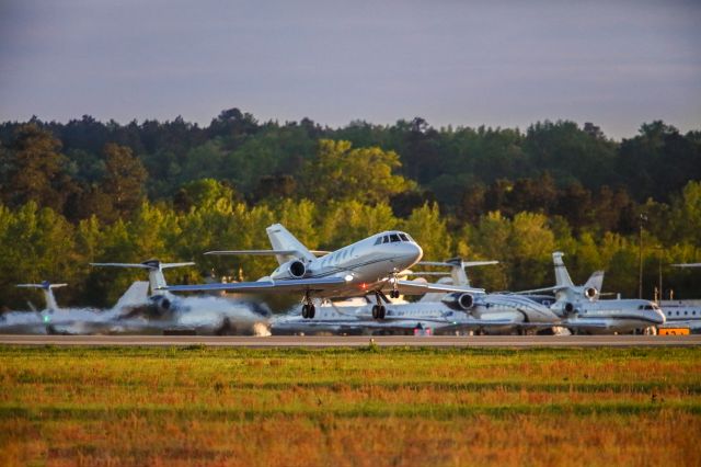 Dassault Falcon 20 (N998BM) - N998BM is a 1988 Dassault Falcon 20, seen here departing Augusta Georgia's regional airport shortly after the conclusion of the 2023 Masters golf tournament. I thought this photo was exceptional as the colors and lighting were amazing in addition to having the background of billionaires row aircraft parking. I shot this with a Canon 5Dsr and a Canon 500mm IS lens and a 1.4 extender on it, making the focal length 700mm. Camera settings were 1/8000 shutter, F5.6, ISO 3200. Please check out my other photography. Positive votes and comments are always appreciated. Questions about this photo can be sent to Info@FlewShots.com