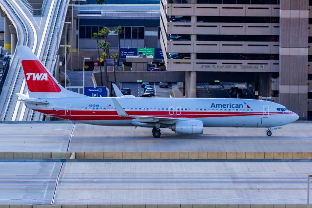 Boeing 737-800 (N915NN) - An American Airlines 737-800 in TWA retro livery taxiing at PHX on 2/28/23. Taken with a Canon R7 and Canon EF 100-400 L ii lens.