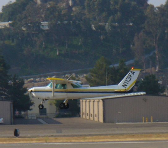 Cessna 152 (N113FA) - Another tired trainer landing 27L.