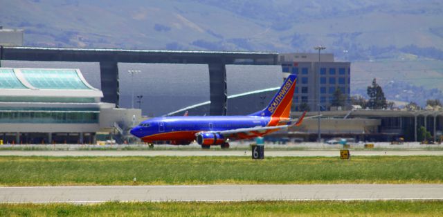 Boeing 737-700 (N212WN) - Southwest - N212WN - In Roll Out as it passes the new Terminal B (L) and Parking Garage (Rear) with the Old Airport Terminal C at the rear of the aircraft ..