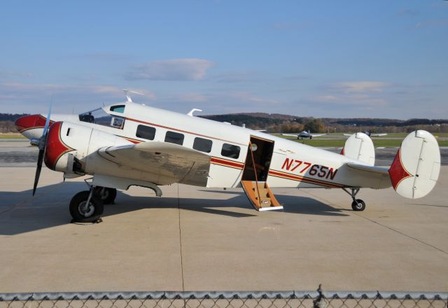 Beechcraft 18 (N7765N) - NTSB Identification: ERA09LA108 14 CFR Part 91: General Aviation Accident occurred Saturday, December 27, 2008 in Fort Myers, FL Aircraft: BEECH E18S, registration: N7765N Injuries: 1 Serious.  <b>HISTORY OF FLIGHT</b>  On December 27, 2008, about 1521 eastern standard time, a Beech E18S, N7765N, was substantially damaged during a forced landing in a wooded area, shortly after takeoff from Florida Southwest International Airport (RSW), Ft. Myers, Florida. The certificated airline transport pilot was the sole occupant on board and was seriously injured. Visual meteorological conditions prevailed, and no flight plan was filed for the executive/business repositioning flight from RSW to Ft. Lauderdale Executive Airport (FXE), Ft. Lauderdale, Florida. The flight was conducted under the provisions of Title 14 Code of Federal Regulations Part 91.  During a phone interview with the pilot, he stated that earlier in the day he had each main and auxiliary fuel tanks filled at FXE. The fueling would have provided him with 270 gallons of fuel; the rear tank in each wing had some fuel, but he did not use the rear tanks to supply fuel to the engines. He flew from FXE to RSW, to pick up the owner of the airplane and several passengers. After he picked up his passengers, he departed from RSW approximately 1130, destined for FXE. About 1500, the airplane returned to RSW, four passengers were unloaded and the pilot was preparing to depart on a return flight to FXE. He stated that prior to departure, he had checked the fuel quantity in each tank via the fuel gauges. The two main tanks and the two wing auxiliary tanks each registered "3/10s fuel." He departed runway 6 and after rotation, while flying at 100 feet above ground level, he raised the landing gear and reduced the engines power from a takeoff power setting to a cruise/climb power of 30 inches manifold pressure and 2,000 rpm. He then noticed that the right engine had lost power. He attempted to feather the right propeller using the feather switch located on the right side of the instrument panel in front of the other pilot seat. He stated that the right propeller did not feather and at that time, he "had not accelerated to blue line airspeed." He switched the fuel selector from the main tank position, to the auxiliary fuel tank position, back to the right main tank position; however, he was not able to restore engine power. He further reported that "all of this occurred within one minute of take-off." The pilot was unable to maintain altitude and the airplane impacted trees. He stated that after the airplane came to a stop, he turned the magnetos and master switch to the OFF position, and exited the airplane through the main cabin entry door.   According to fuel receipts from a fixed based operator located at FXE, the airplane was last fueled with 170.7 gallons of aviation gasoline on December 7, 2008.  <b>PERSONNEL INFORMATION</b>  The pilot held an airline transport pilot certificate, with ratings for airplane multiengine land, airplane multiengine sea, and instrument airplane. He held a commercial pilot certificate, with ratings for airplane single-engine land, airplane single-engine sea, and glider. His most recent Federal Aviation Administration (FAA) first-class medical certificate was issued May 8, 2008. He reported approximately 14,000 total hours of flight experience; of which, 195 hours were in the accident aircraft make and model.  <b>AIRPLANE INFORMATION</b>  The airplane had been manufactured in 1959 and had undergone an annual inspection on February 1, 2008. At that time, the airplane had accrued 9,193 total hours of flight time. The airplane was equipped with two Pratt and Whitney R-9085AN-14B engines, which had been overhauled about 1 year prior to the accident. The left engine had accrued 74 total hours since overhaul and the right engine had accrued 82 total hours since overhaul. According to the airplanes flight log, on the day of the accident, the airplane had flown three flights totaling 2.5 hours of flight time. Prior to the day of the accident, the airplane had last flown on December 7, 2008.  <b>WRECKAGE AND IMPACT INFORMATION</b>  Examination of the airplane by an FAA inspector revealed that the left engine had separated from the left wing and was located approximately 40 yards from the wreckage, near the first tree strike, and the left propeller exhibited no signs of damage. The right engine was still attached to the right wing and the right propeller exhibited signs of tip damage. The airplane had impacted a tree, rotated, and came to rest facing the opposite direction of travel. The empennage was twisted approximately 90 degrees. Control continuity was verified for all control surfaces. The left wing exhibited signs of leading edge crushing. Examination of the cockpit revealed that the throttle levers were full forward, the left propeller lever was approximately three-fourths forward and the right propeller lever was approximately one-fourth forward. Both mixture controls were one-fourth forward, the left fuel selector was in the forward position and the right fuel selector was in the OFF position. The auxiliary wing fuel tanks were ruptured, but there was evidence of fuel. The main wing fuel tanks were void of fuel and the rear auxiliary wing fuel tanks contained some fuel.  <b>TESTS AND RESEARCH</b>  Examination of the engines by a local airframe and powerplant mechanic, with FAA oversight, revealed no external damage. No contaminations were found in the oil filter assembly, fuel screens located on the airframe, the fuel screen assemblies located in the carburetor for both engines. Additionally, no fuel was found in the carburetor for the right engine. The spark plugs for both engines were examined and appeared normal. The supercharger impeller for the right engine supercharger was checked and operated at that time. The oil lines to the propeller and propeller governor were secure and in place. The fuel control levers were inspected and operated normally.  Examination of the right engine feathering oil pump was conducted after recovery of the aircraft. The examination concluded that all items tested, including the right engine feathering oil pump, "appeared to function normally and as anticipated."  According to the airplane flight manual (AFM) for the accident airplane model, the main fuel tanks were equipped with electric, submerged boost pumps, and have sufficient capacity to supply the engines at take-off power should the engine-driven fuel pumps fail. The manual also states that "fuel should be used first from the auxiliary tanks, so that the main tanks are available for take-off, landing and flight through rough air." The Pre-Start Checklists states that the "fuel selector valves on to main tanks." The Cruise portion of the manual states in part "Then set up cruising power best suited to your situation…The fuel boost pumps should be turned off, the fuel selector handles switched to use fuel as required…"  In Section IV of the AFM, under the section titled "Single-Engine Operation," states in part "The optimum single-engine rate-of-climb speed at sea level is 116 mph IAS [Indicated Air Speed] ("blue line" on the airspeed indicator). Maintaining this speed is of extreme importance if best aircraft performance is to be attained during stimulated or actual emergency conditions."   <a href="<a rel="nofollow" href="a rel=nofollow href=http://www.ntsb.gov/aviationquery/brief2.aspx?ev_id=20081228X52120&ntsbno=ERA09LA108&akey=1"">http://www.ntsb.gov/aviationquery/brief2.aspx?ev_id=20081228X52120&ntsbno=ERA09LA108&akey=1"</a&gthttp://www.ntsb.gov/aviationquery/brief2.aspx?ev_id=20081228X52120&ntsbno=ERA09LA108&akey=1"">http://www.ntsb.gov/aviationquery/brief2.aspx?ev_id=20081228X52120&ntsbno=ERA09LA108&akey=1"</a>/a;; rel="nofollow"><a rel="nofollow" href="a rel=nofollow href=www.ntsb.gov/aviationquery/brief2.aspx?ev_id=20081228X521...</a>">www.ntsb.gov/aviationquery/brief2.aspx?ev_id=20081228X521...</a></a&gtwww.ntsb.gov/aviationquery/brief2.aspx?ev_id=20081228X521...</a>">www.ntsb.gov/aviationquery/brief2.aspx?ev_id=20081228X521...</a></a>/a;;