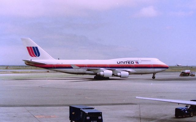 Boeing 747-400 (N187UA) - KSFO - United Airlines early 747-4 arriving at the old International terminal at San Francisco. Early mid 1990s. CN:26876 LN: 939 viewed from the American Airlines terminal back when one could walk the terminals freely.