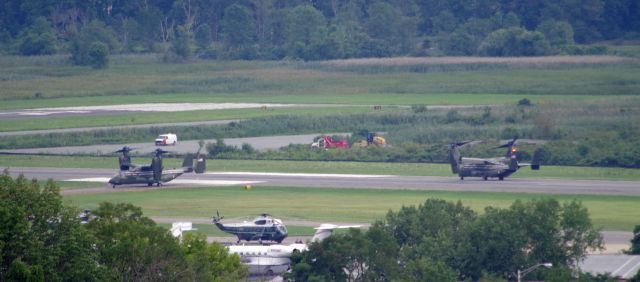 Bell V-22 Osprey — - MORRISTOWN, NEW JERSEY, USA-AUGUST 14, 2020: On a cloudy and overcast day, two U.S. Marine V-22 Osprey tilt-rotor aircraft are seen taxiing into position near Marine One at Morristown Municipal Airport. The Marine One detachment this time consisted of two Sikorsky helicopters and three V-22 Ospreys. President Trump is spending the weekend at his golf club in Bedminster, New Jersey and Air Force One will be landing in approximately one hour. Photo taken from approximately one mile away.