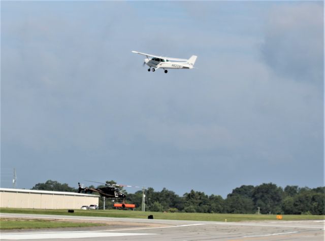 Cessna Skyhawk (N62281) - Aircraft taking off while a Georgia State Patrol helicopter, N617HC, moves along the taxiway.  The helicopter is on route to be viewed by the crowd at the 2017 Cracker Fly In. 