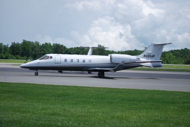 Learjet 60 (N420JP) - NASCAR driver Juan Pablo Montoya taxiing out to runway 20 at KJQF - 5/26/09