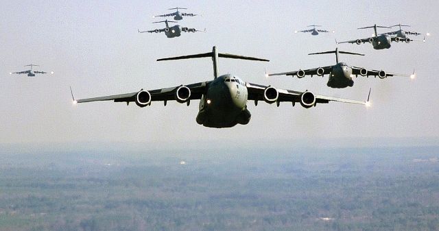 — — - A fleet of C-17s flying near one another.