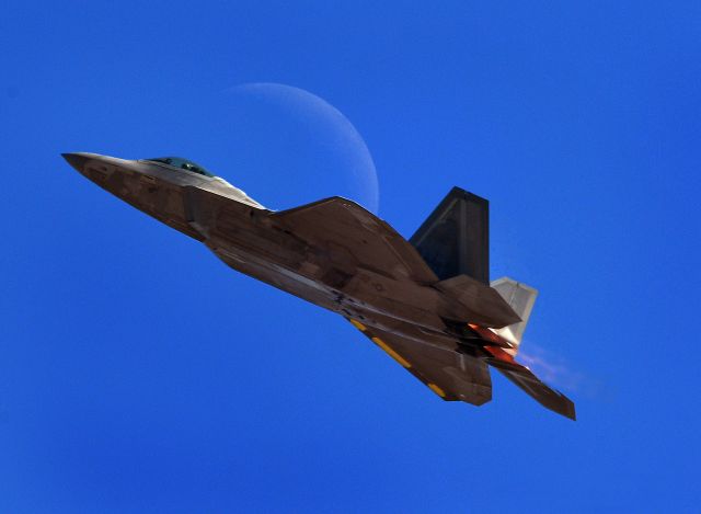 McDonnell Douglas MD-83 (WAL2017) - During a Demo performance at the Capitol Air show at Mather field West coast F-22 raptor demo team soloist preforms climb passing a crescent moon