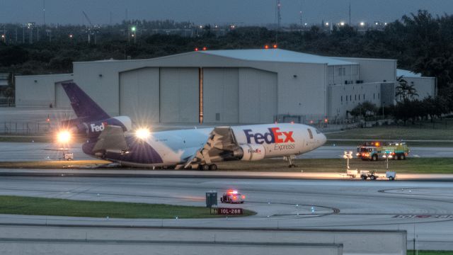 — — - N370FE operating as FDX910 left mg collapse on 10L landing 28 Oct 2016 1750L (2150Z). Aircraft came to rest appx. 6580 ft down the 9000 ft runway, between Quebec and A4 taxiways.   ARFF call to first foam was 90 seconds (per BCAD).  Crew escaped safely via starboard cockpit line. Underwriters value of a/c estimated at US$10.5M.  Image of FLL crash site predawn from the Hibiscus garage (looking NNW) the morning following the incident.