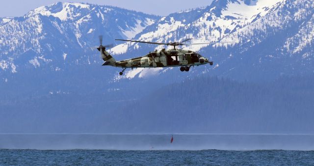 Sikorsky S-70 (16-7822) - Navy NAWDC MH-60S helicopter 73 (167822) lowers a harness to a Navy pilot floating in the cold water of Lake Tahoe during a "Downed Flier Rescue" training exercise on 05 Jun 23.br /137v/14h   166v/23h