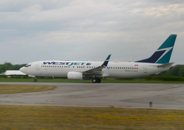 Boeing 737-700 (C-FWIJ) - Wheels coming up on takeoff from Hamilton. 