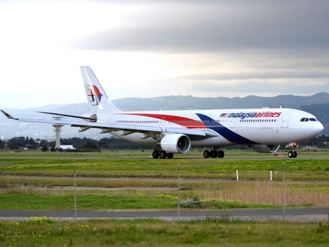 Airbus A330-300 (9M-MTC) - On taxi-way heading for take off on runway 05, for flight home to Kuala Lumpur, just before the arrival of a rain storm. Thursday 12th July 2012.