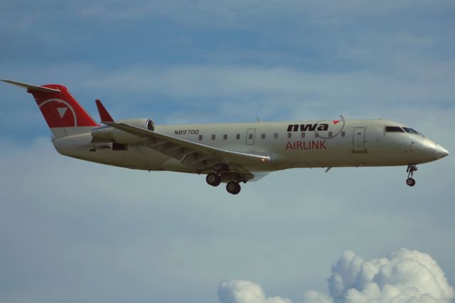 Canadair Regional Jet CRJ-200 (N8970D) - 2010:08:17. 15:46 Landing runway 25. Note position of horizontal stabiliser. Very gusty headwind. Nice light from low sun.