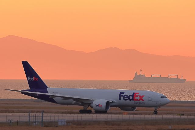 BOEING 777-200LR (N873FD) - 夕暮れ時に太陽の光りを浴びながらbr /出発にむけて進んでいる。