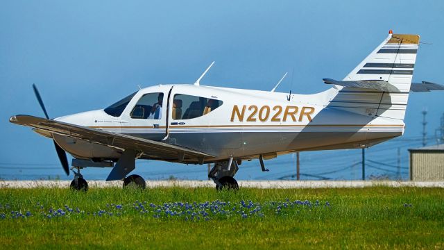Rockwell Commander 114 (N202RR) - Taxiing past some Bluebonnets back in April 2017.