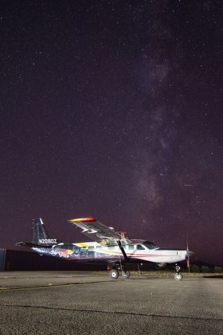 Cessna Caravan (N208DZ) - Skydiving plane N208DZ remains parked on the tarmac at Belen, New Mexico in front of the Milky Way during a solar eclipse skydiving event