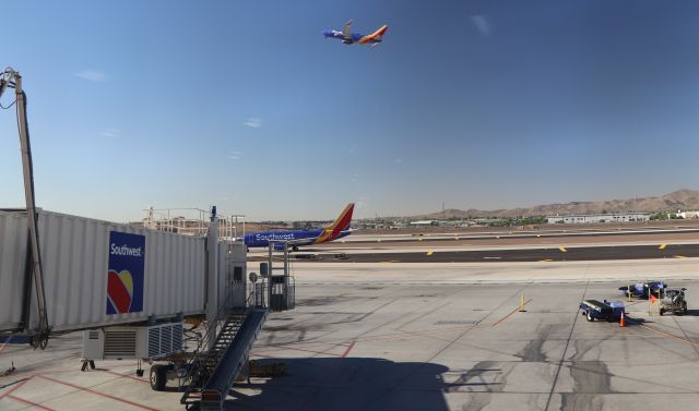 Boeing 737-700 (N413WN) - 6/19/18 N413WN turns in to the terminal as another SWA bird departs