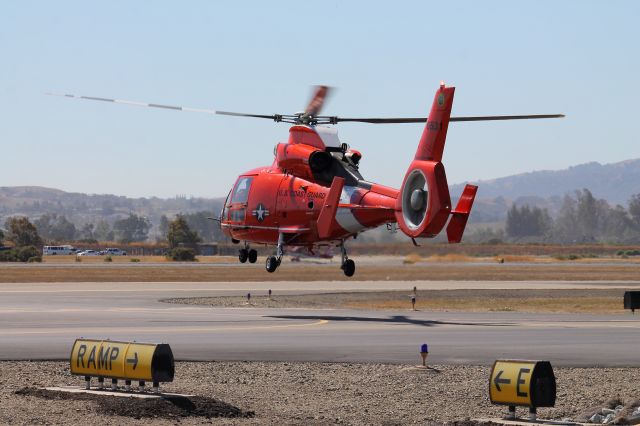 — — - US Coast Guard HH-65 lifts off the ground to head back to SFO