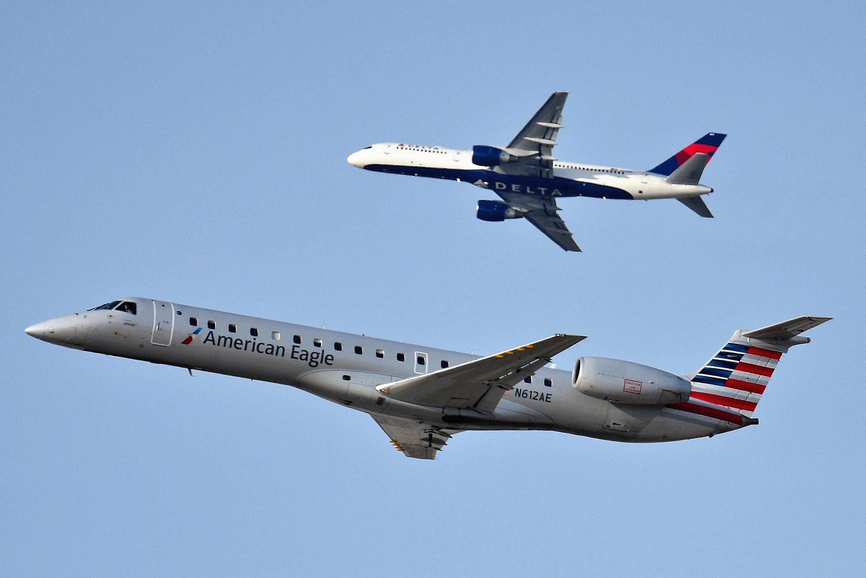 Embraer ERJ-145 (N612AE) - Eagle departing 28-R, with DL 757 departing off of 27-L in background. Shown on 03-19-19